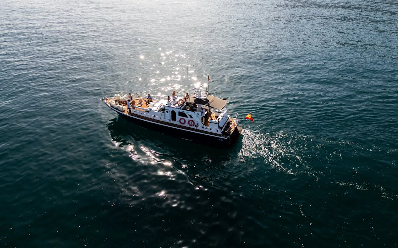 Cruise boat on Mediterranean Sea during Benalmádena sunset tour with tasting menu.
