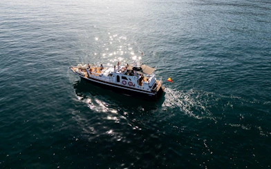 Cruise boat on Mediterranean Sea during Benalmádena sunset tour with tasting menu.
