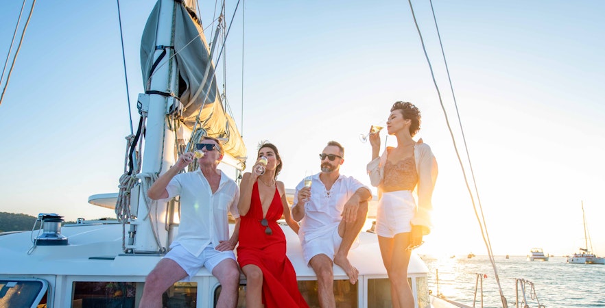 Group enjoying drinks on a yacht during a Bosphorus cruise at sunset.