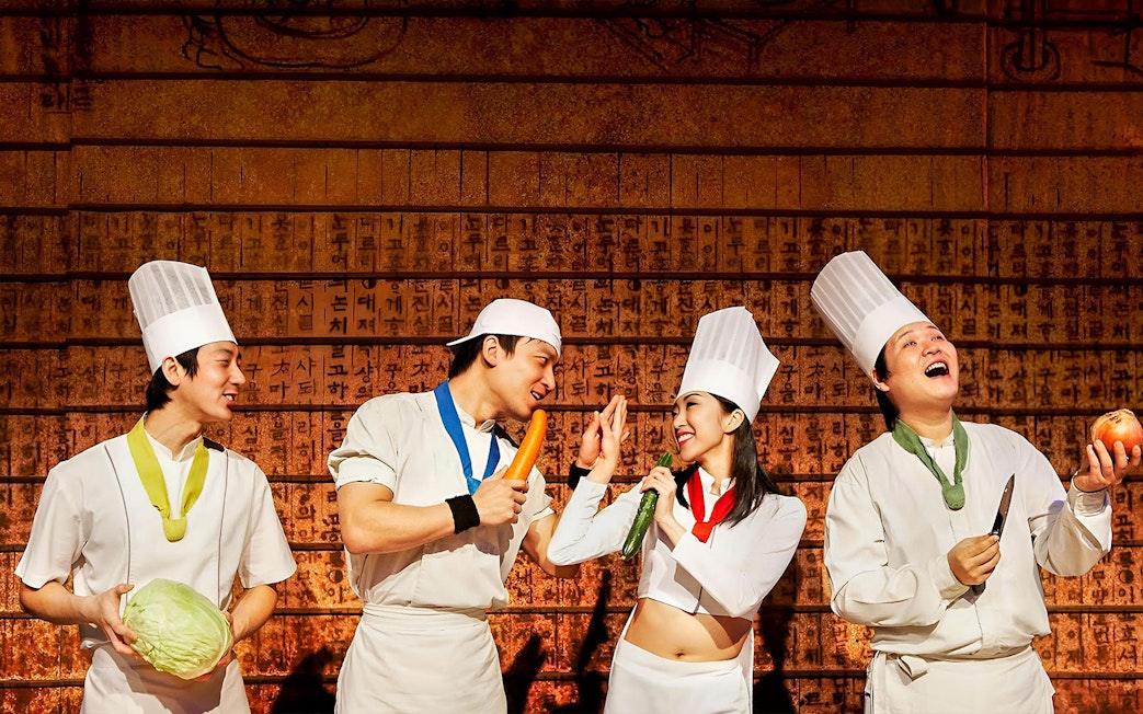 Chefs performing with vegetables at Jeju Nanta Musical Show.