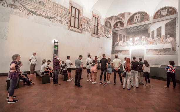 Tourists viewing the Last Supper painting in Milan during a city walking tour near Milan Cathedral.