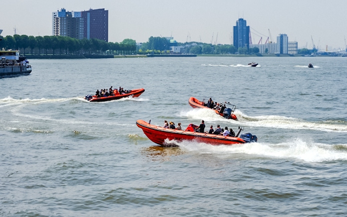 RIB speedboats with passengers touring Rotterdam Harbour.