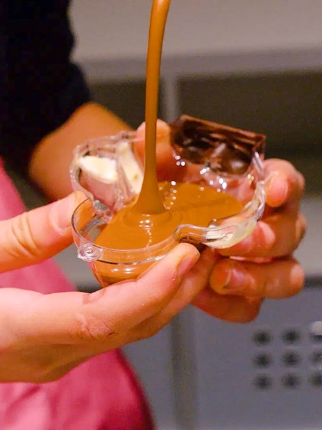 Pouring chocolate into a mold at Choco-Story Paris.