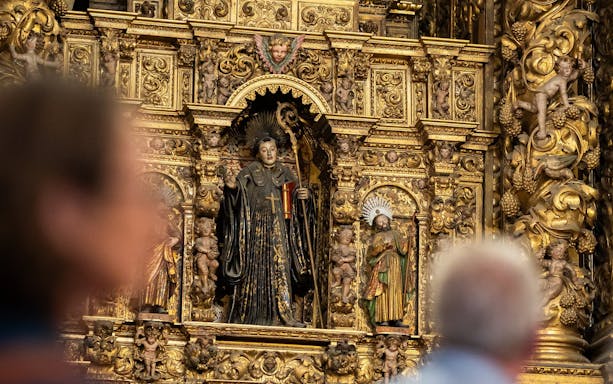 Ornate altar with religious statues inside Mosteiro de São Bento da Vitória, Porto, Portugal.