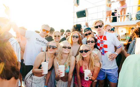 Guests enjoying a sunset boat party in Split, Croatia, with drinks and music.