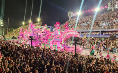 Carnival parade with vibrant floats and dancers at Marquês de Sapucaí, Rio de Janeiro.