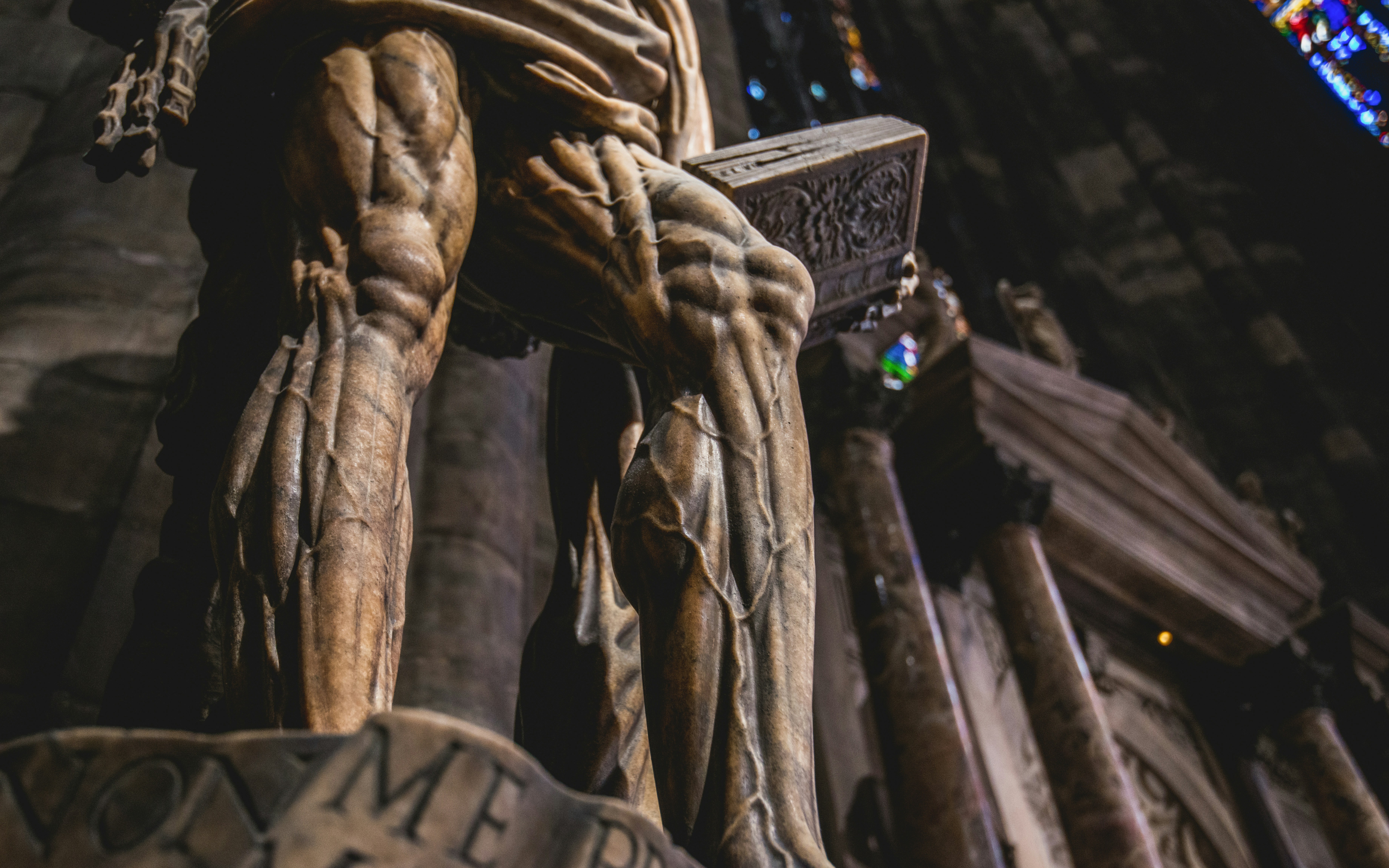 Saint Bartholomew statue closeup in Duomo Milan, showcasing detailed anatomy.