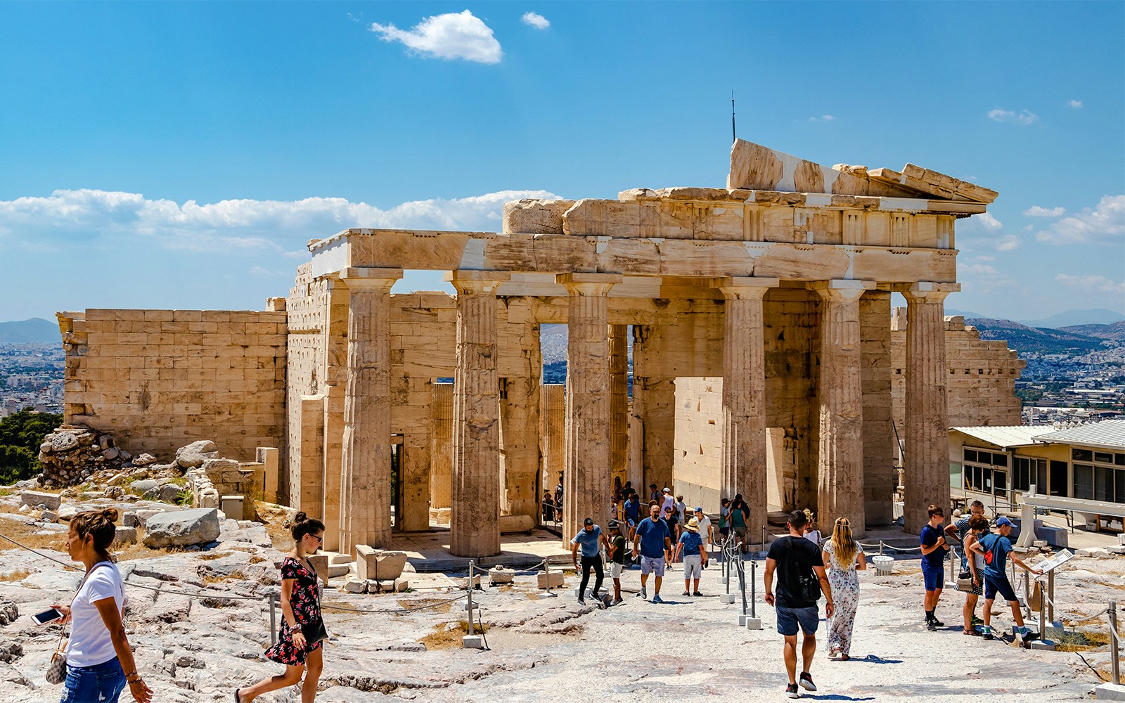 Visitors exploring the Propylaea at the Acropolis in Athens, Greece.
