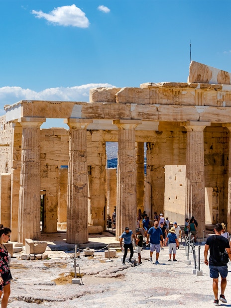 Visitors exploring the Propylaea at the Acropolis in Athens, Greece.