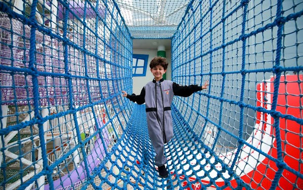 Child navigating rope bridge at CITY STUDIO, Angry Birds World Theme Park.
