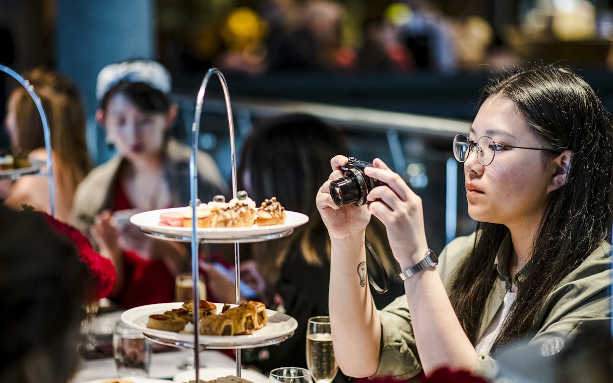 Guests enjoying high tea with pastries at National Gallery of Victoria.