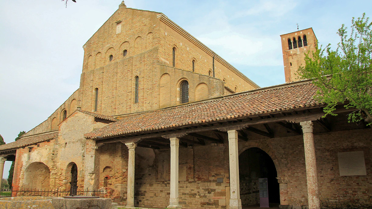 Basilica di Santa Maria Assunta in Torcello with brick facade and bell tower.