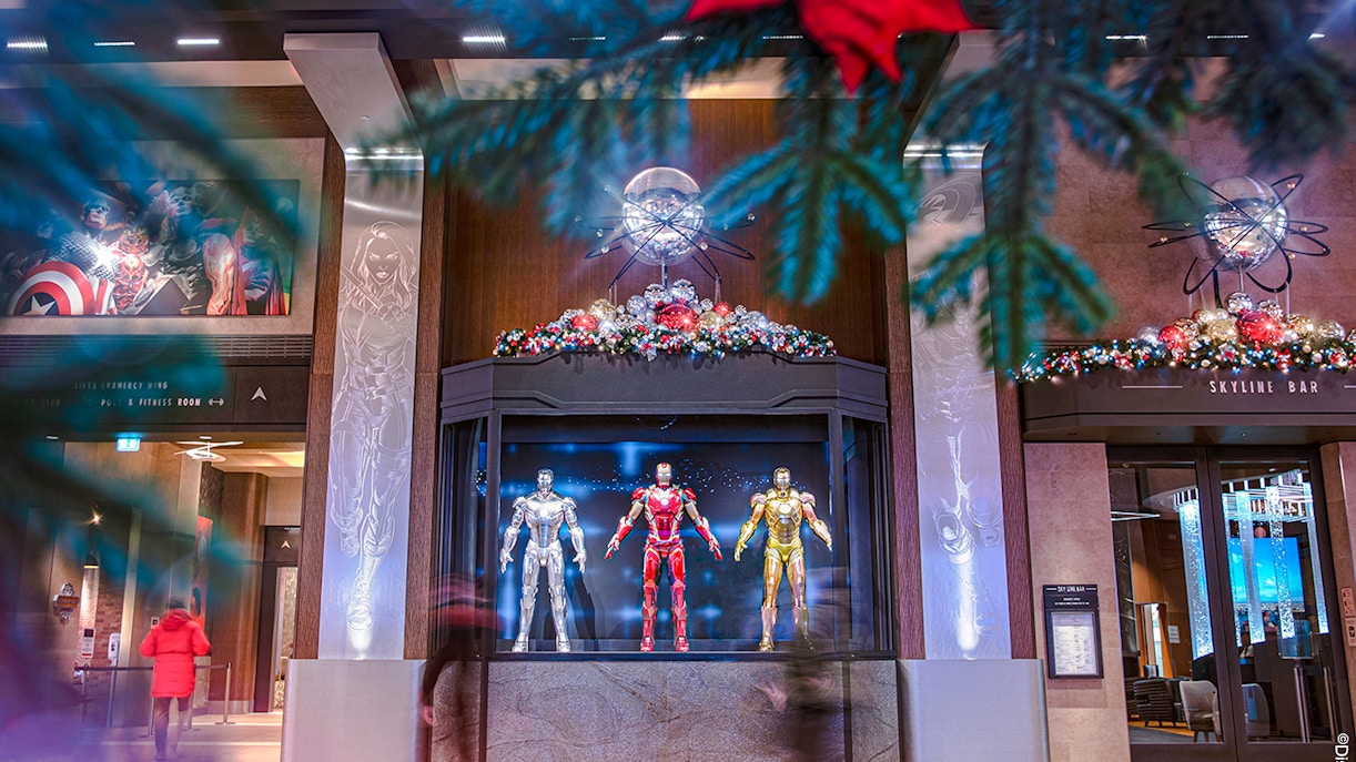 Iron Man suits display at Disneyland Paris during Christmas 2025, with festive decorations.