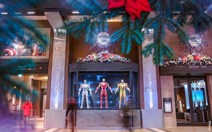 Iron Man suits display at Disneyland Paris during Christmas 2025, with festive decorations.