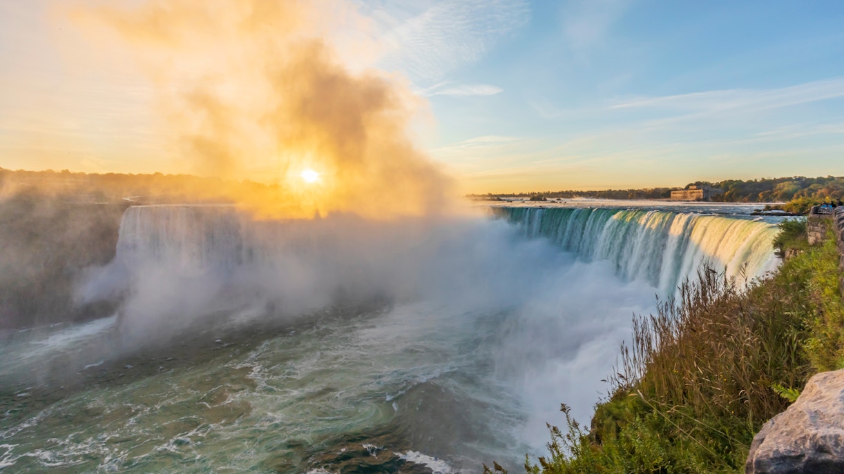 Niagara Falls at sunset with vibrant sky and cascading water, highlighting the natural beauty of this iconic landmark.
