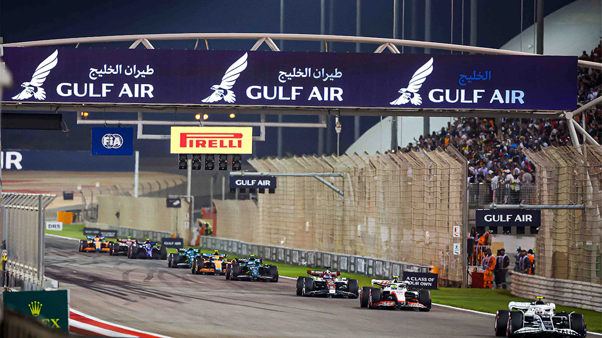 Formula 1 cars racing at Bahrain Grand Prix under Gulf Air signage.