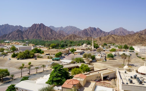 Heritage Village with mosque and mountains at Hatta Dam, UAE.