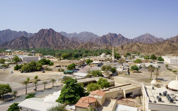 Heritage Village with mosque and mountains at Hatta Dam, UAE.