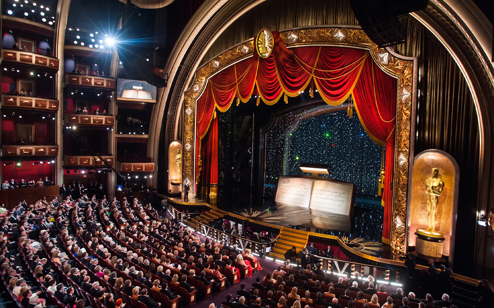 Audience inside the Dolby Theatre during a live event with a decorated stage.