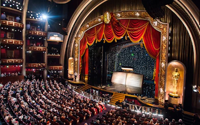 Audience inside the Dolby Theatre during a live event with a decorated stage.