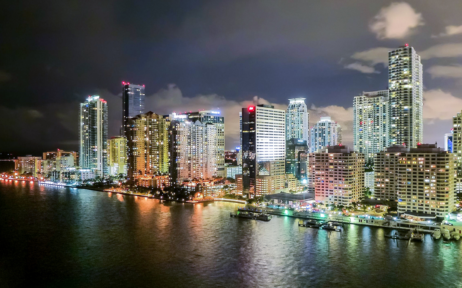 Miami skyline at night viewed from a luxury yacht on the Millionaire's Homes cruise.