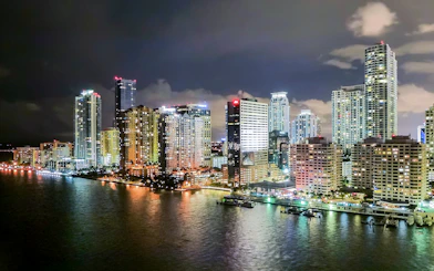 Miami skyline at night viewed from a luxury yacht on the Millionaire's Homes cruise.