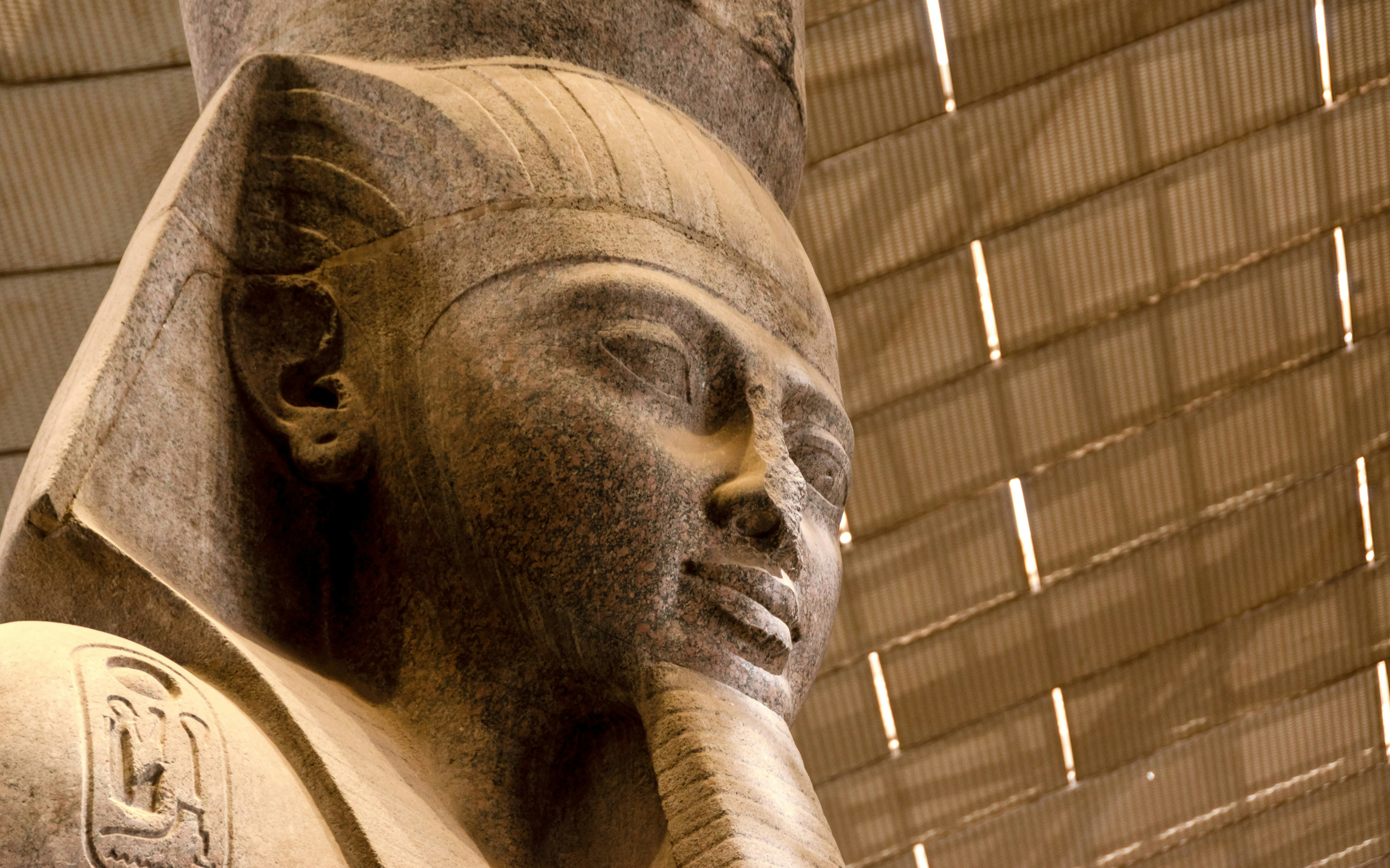 Colossal statue of Pharaoh Ramesses II in Grand Egyptian Museum atrium.