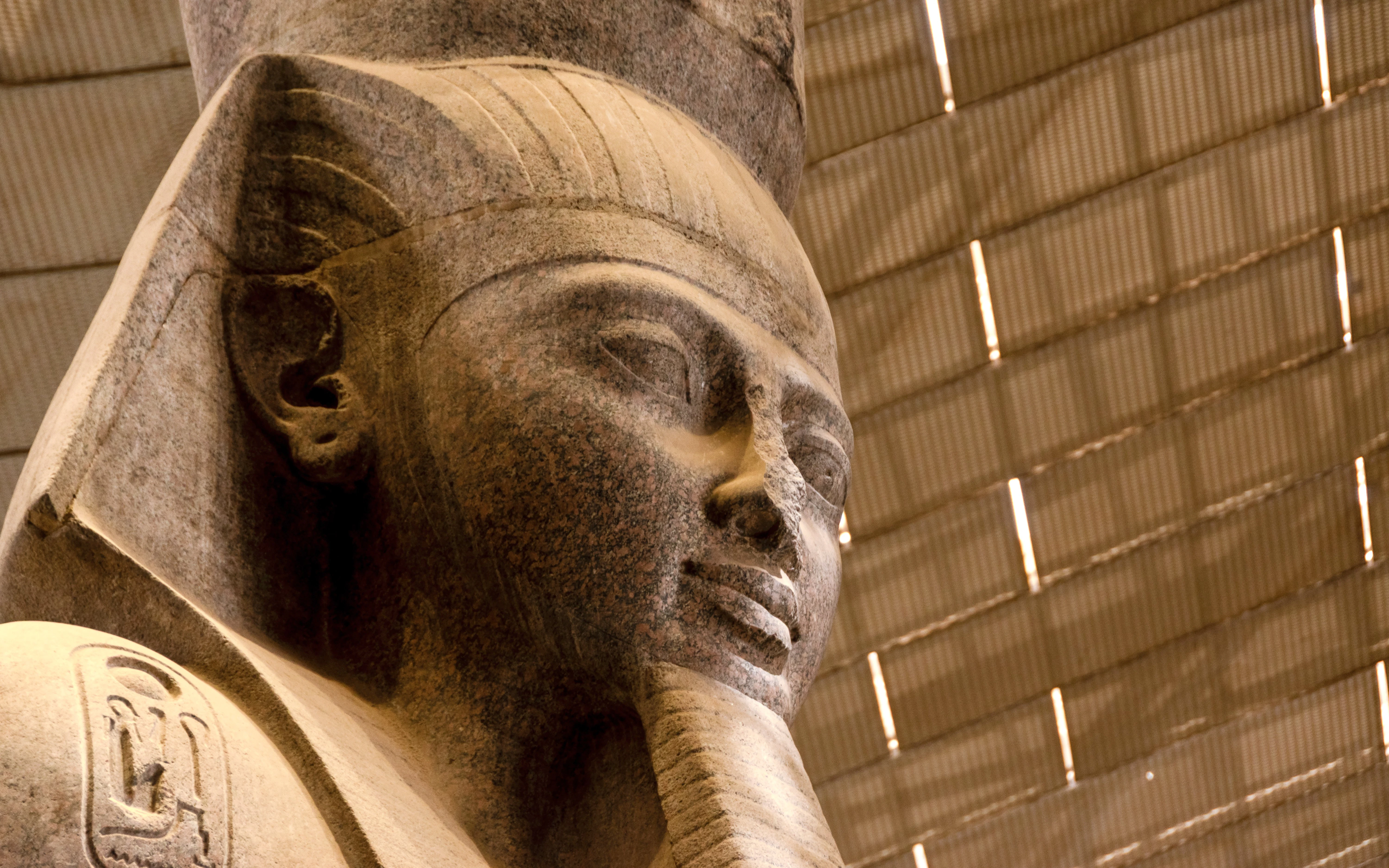Colossal statue of Pharaoh Ramesses II in Grand Egyptian Museum atrium.