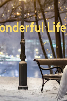 Snowy park scene with angel wings on a bench, lights in the background, "It's a Wonderful Life" text.