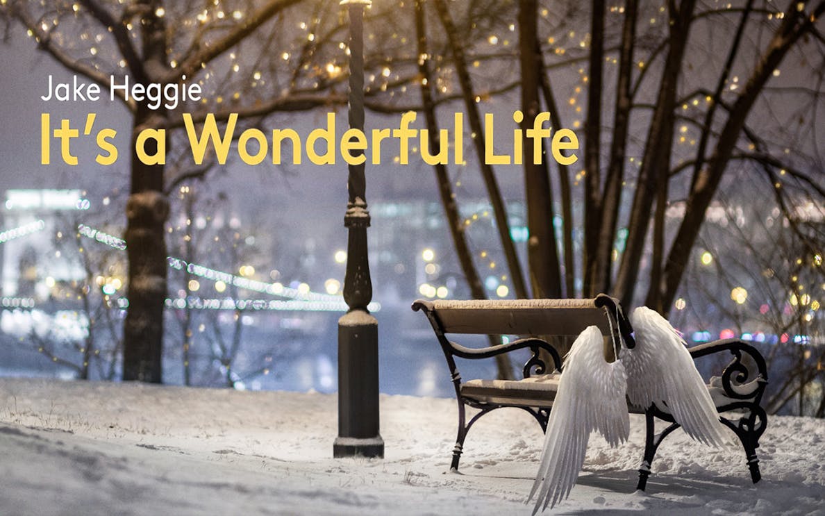 Snowy park scene with angel wings on a bench, lights in the background, "It's a Wonderful Life" text.