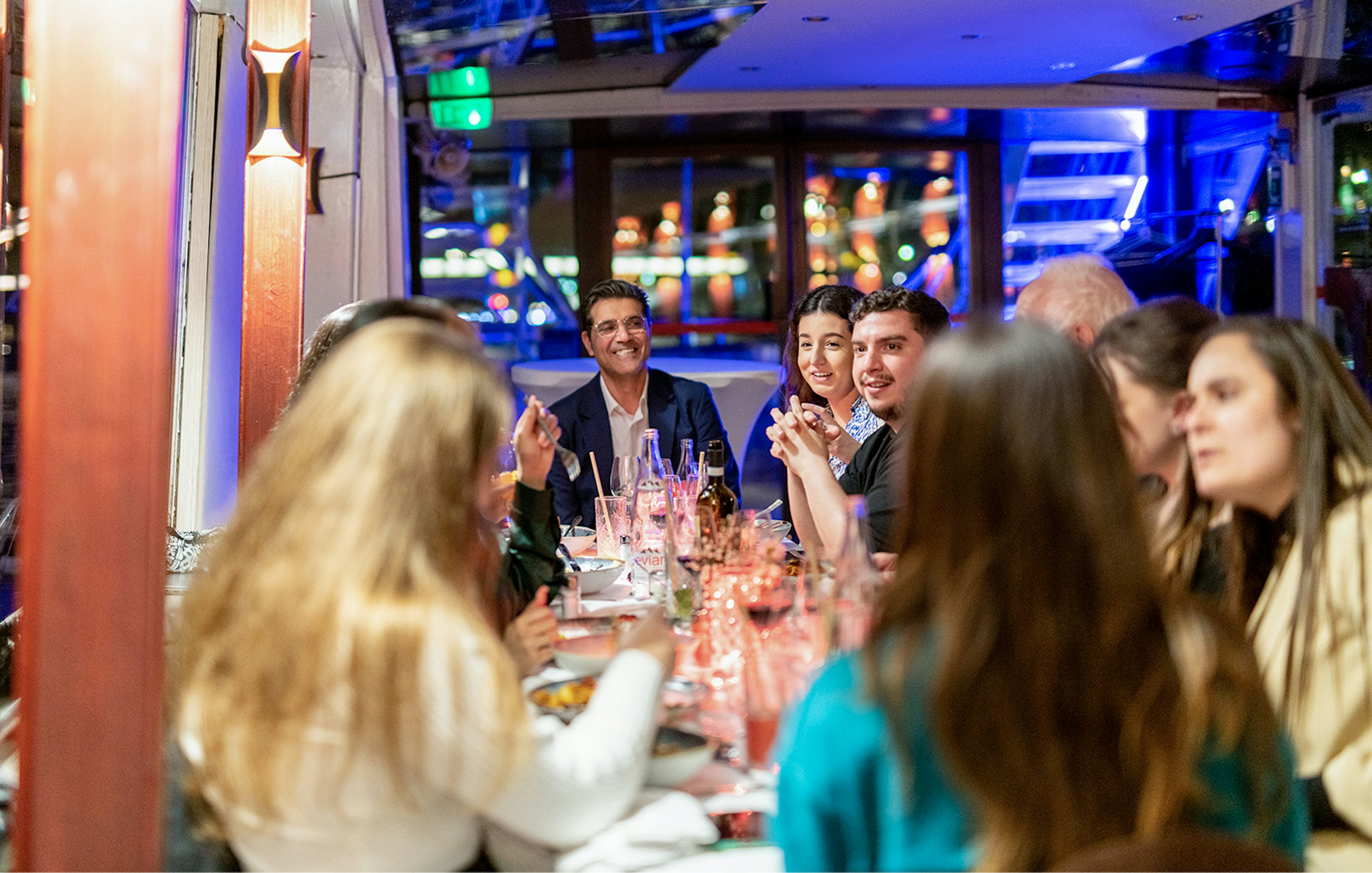 Guests enjoying Italian dinner on THEO boat cruise in Paris.
