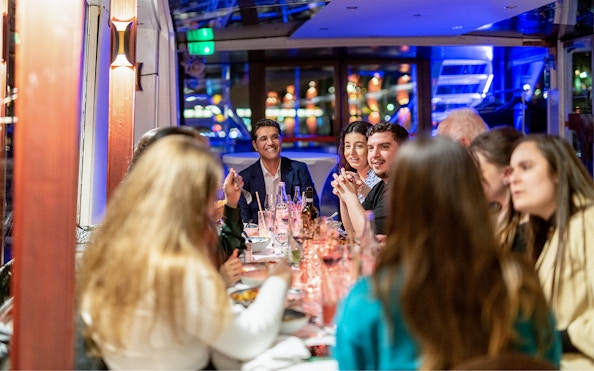 Guests enjoying Italian dinner on THEO boat cruise in Paris.