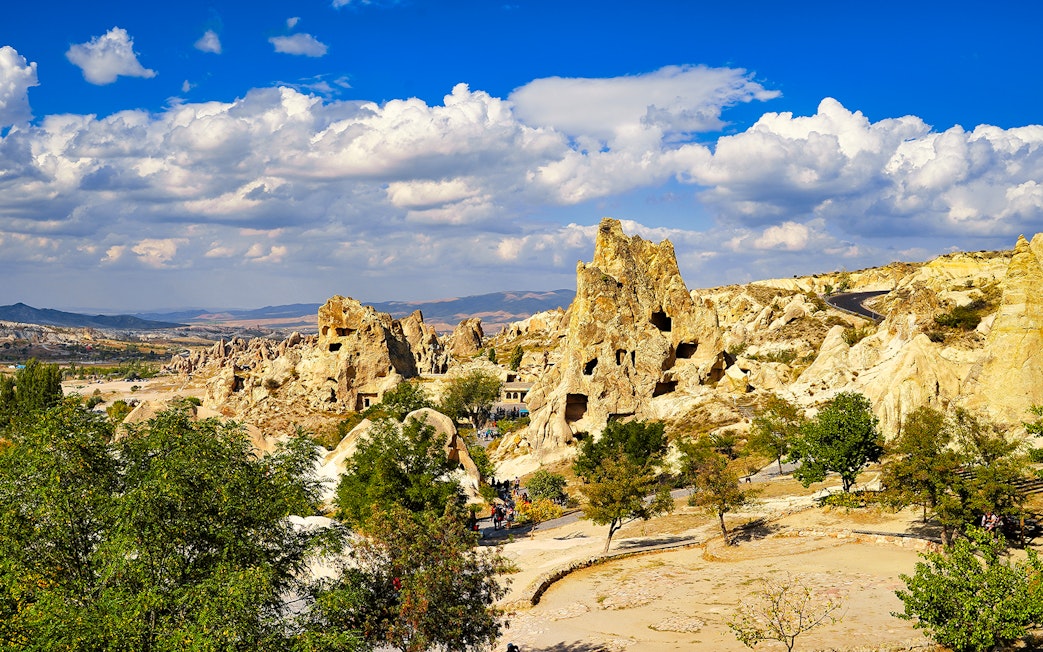 Goreme Open Air Museum rock formations under a blue sky in Cappadocia, Turkey.