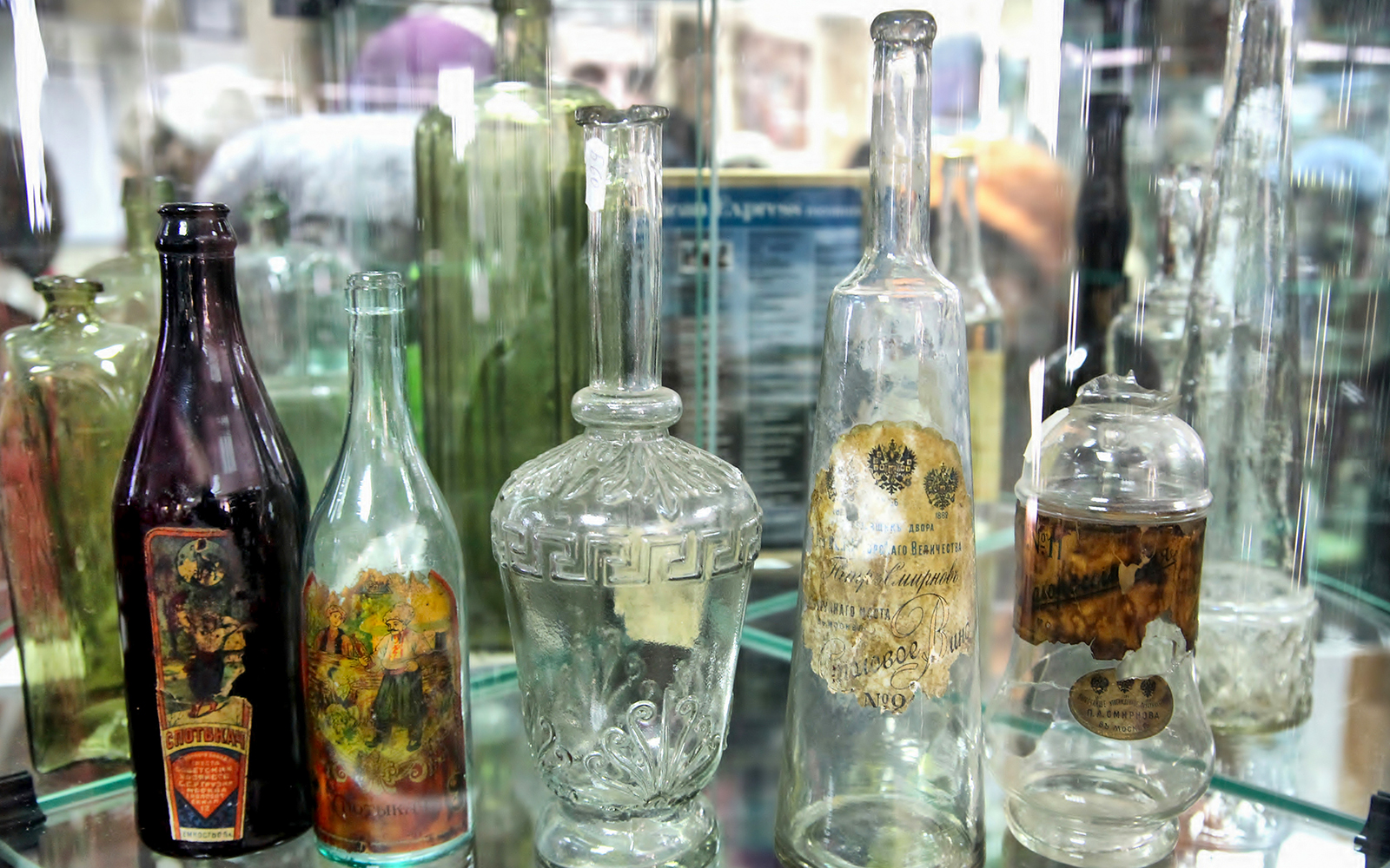 Antique glass bottles displayed in a Warsaw museum exhibit.