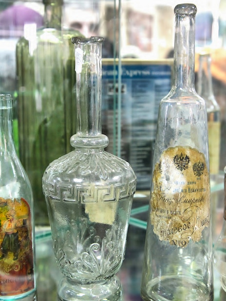 Antique glass bottles displayed in a Warsaw museum exhibit.