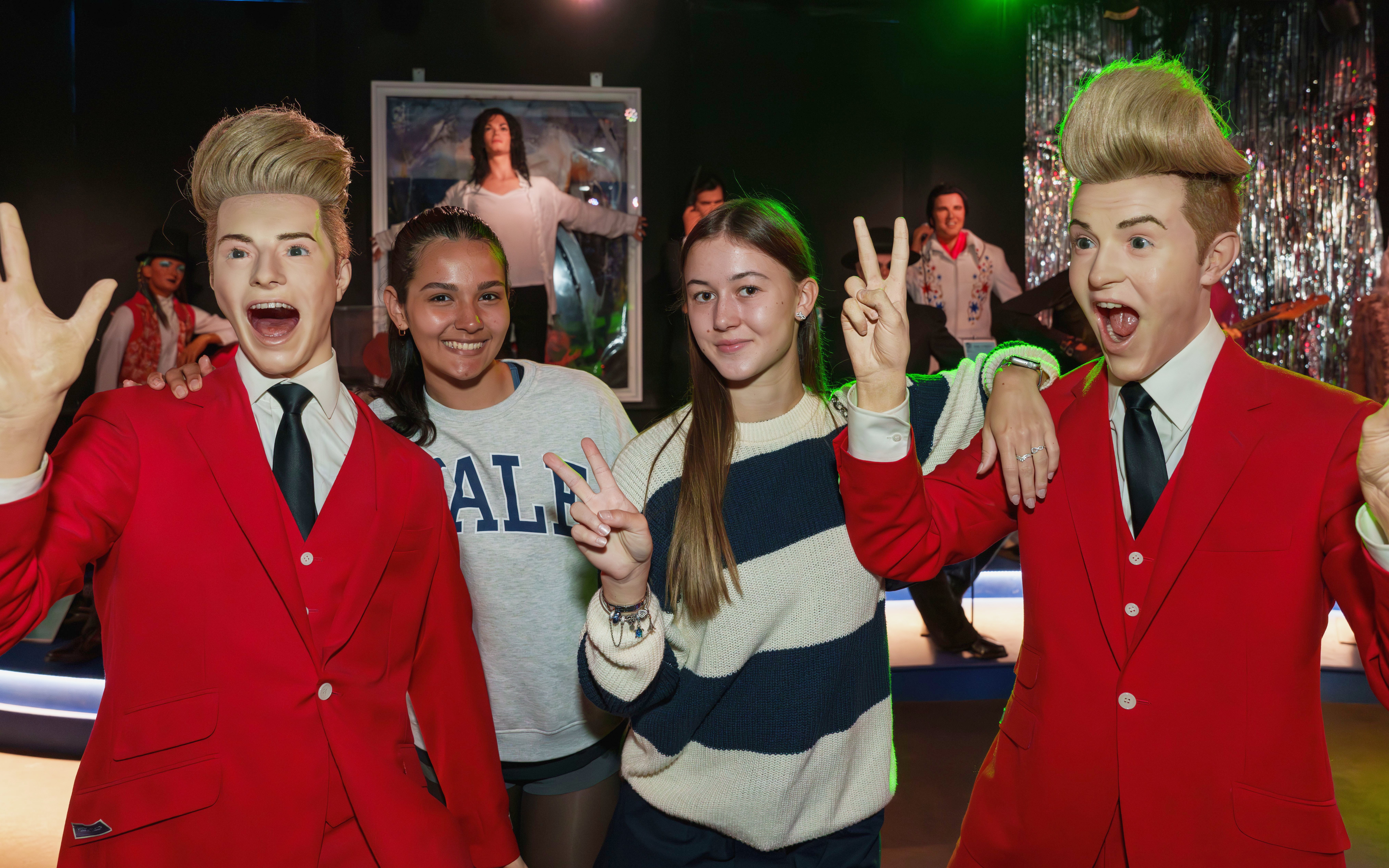 Visitors posing with wax figures at the National Wax Museum.