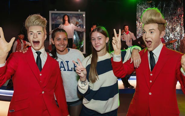 Visitors posing with wax figures at the National Wax Museum.