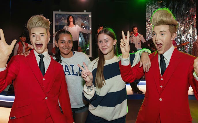 Visitors posing with wax figures at the National Wax Museum.