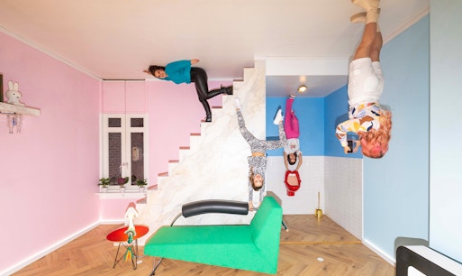 Visitors exploring Dutch Design Room at Upside Down Amsterdam with interactive exhibits.