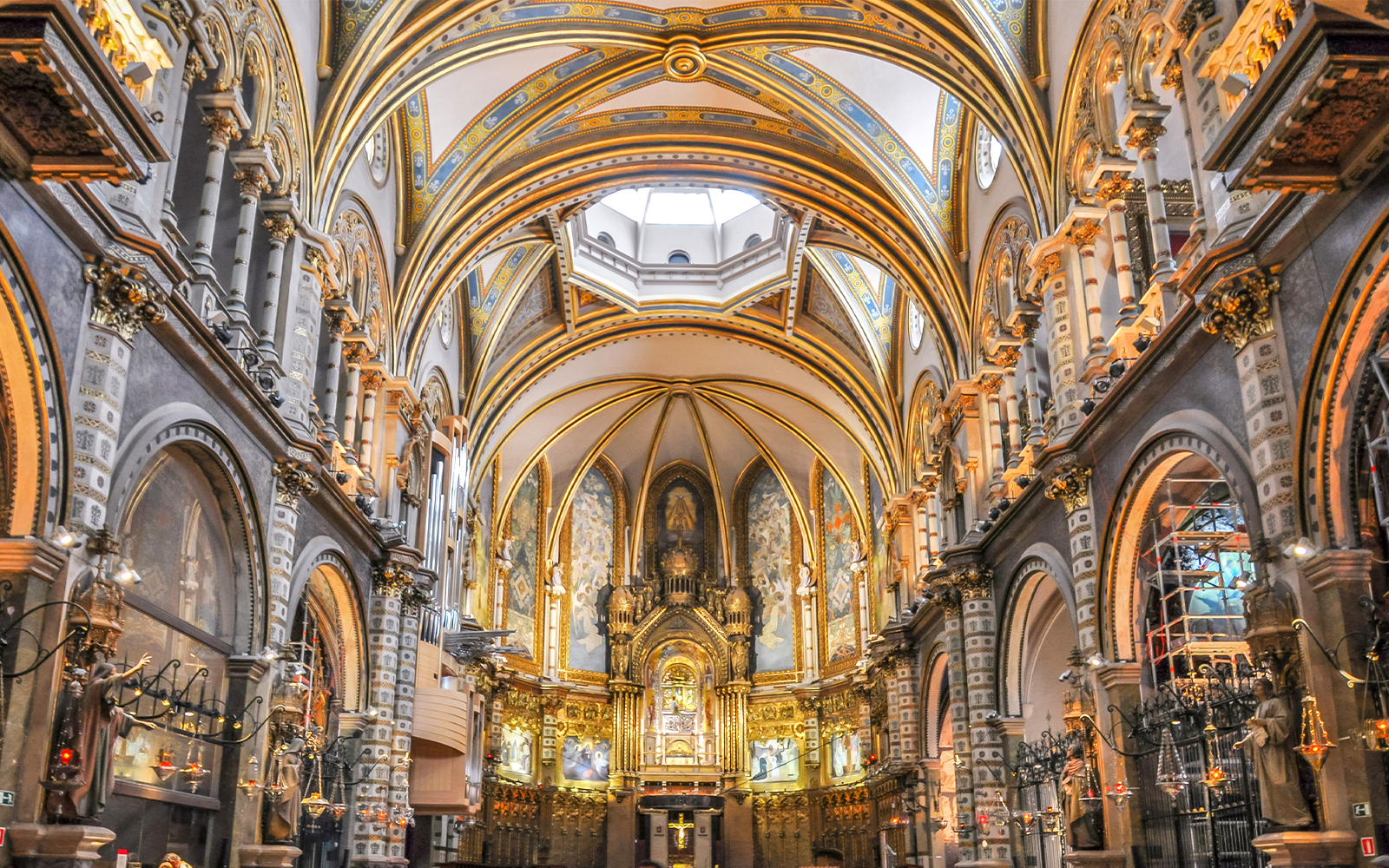 Interior of Montserrat Monastery with ornate arches and altar, Barcelona.