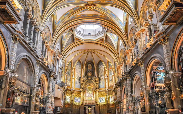 Interior of Montserrat Monastery with ornate arches and altar, Barcelona.