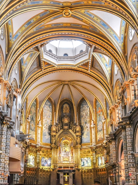 Interior of Montserrat Monastery with ornate arches and altar, Barcelona.