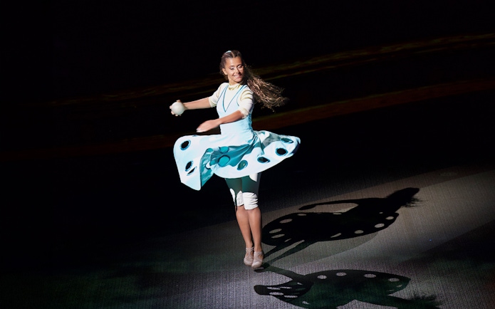 Performer spinning on stage at La Perle by Dragone show in Dubai.