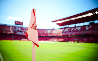 Ramón Sánchez Pizjuán Stadium with Sevilla FC corner flag on the field.