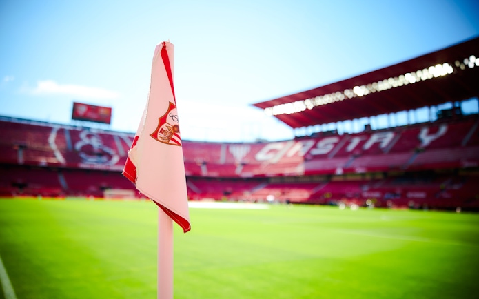 Ramón Sánchez Pizjuán Stadium with Sevilla FC corner flag on the field.