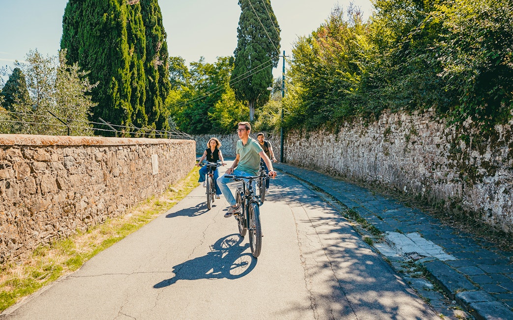 Cyclists on an electric bike tour through scenic Florence hills.