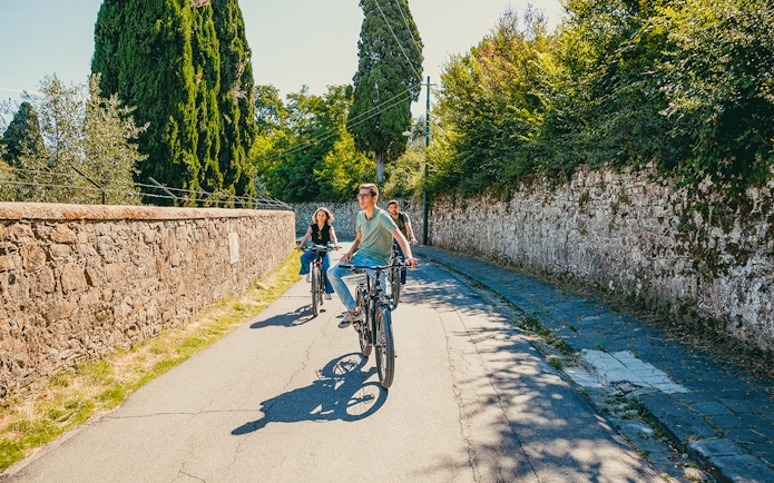 Cyclists on an electric bike tour through scenic Florence hills.