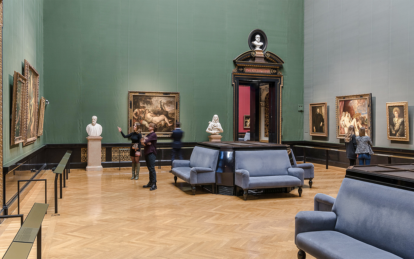 Guide explaining artwork inside Kunsthistorisches Museum, Vienna.