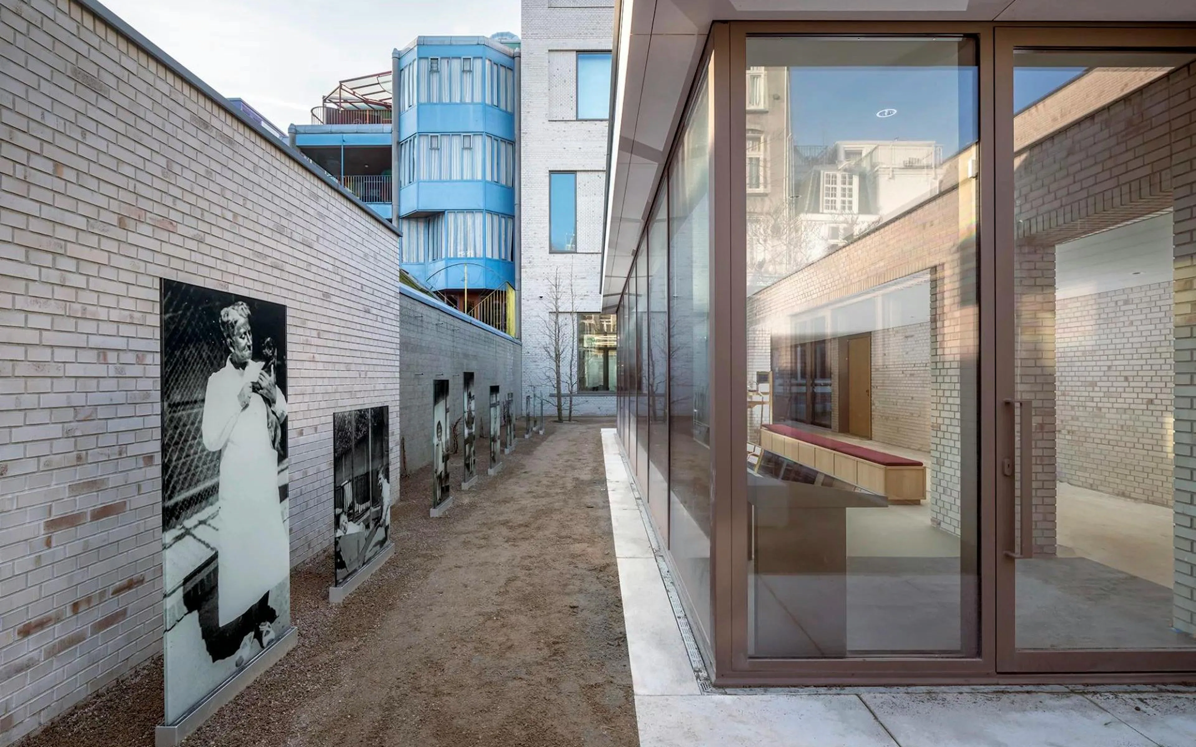 Outdoor exhibit at the National Holocaust Museum featuring historical photographs on a brick pathway.