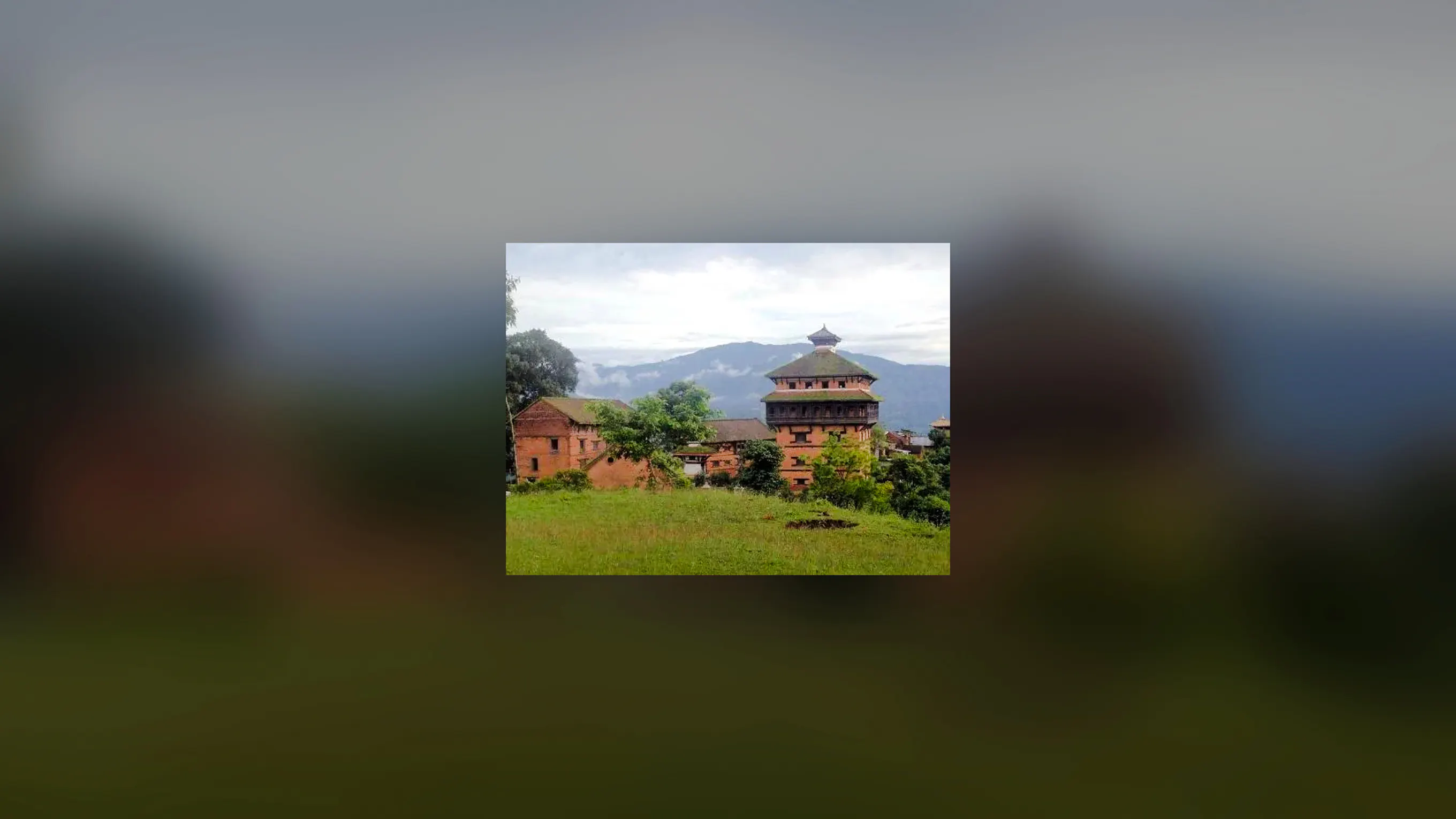 Bhaktapur temple with traditional Newari architecture, surrounded by greenery and mountains.